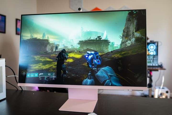 The Samsung M8 smart monitor in pink placed on a black desk.